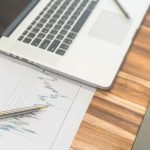 9 Financial Habits That Separate Stability From Struggle Financial charts on the table with laptop .